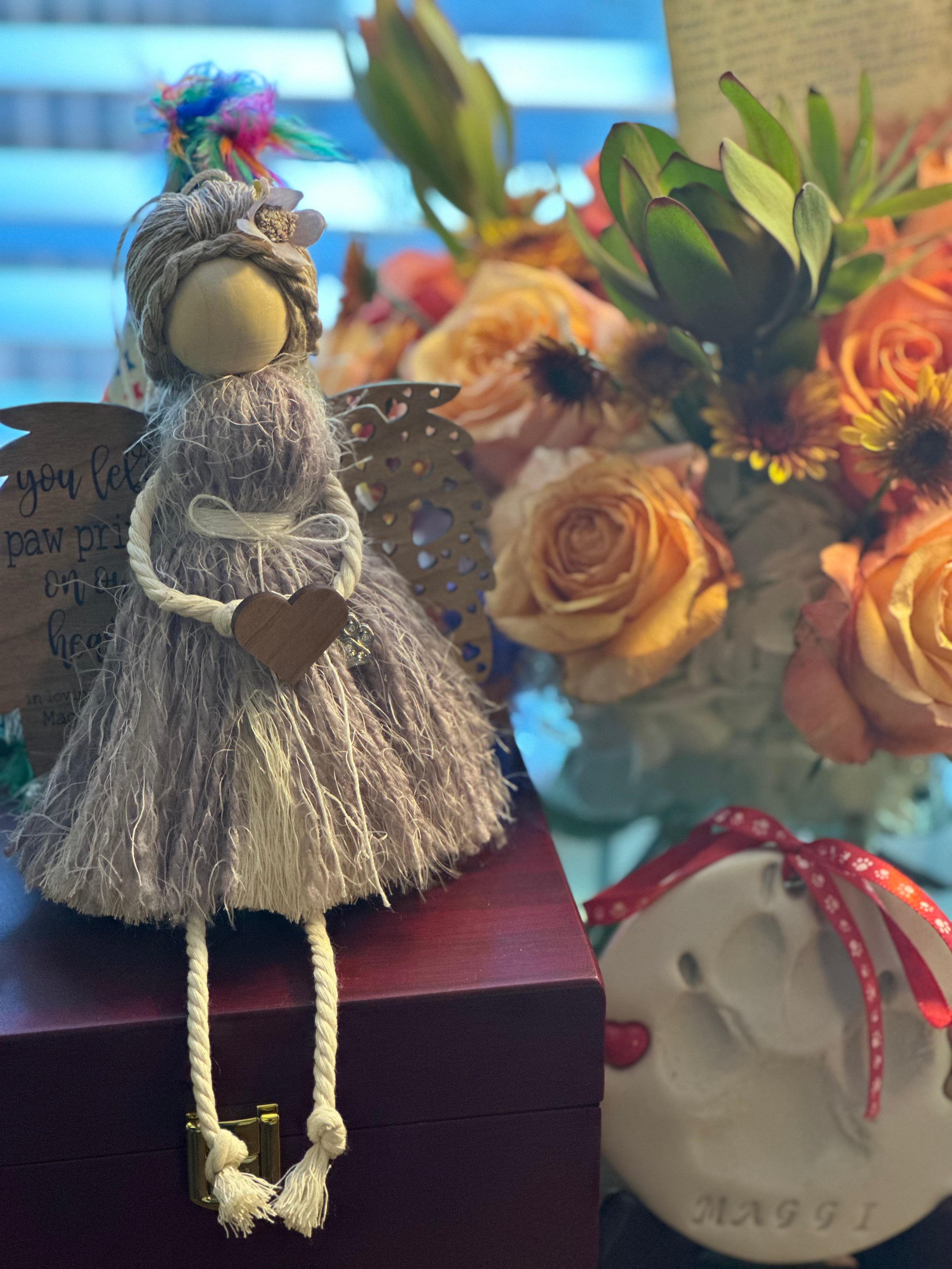 This image shows the angel sitting on the memorial pet box.