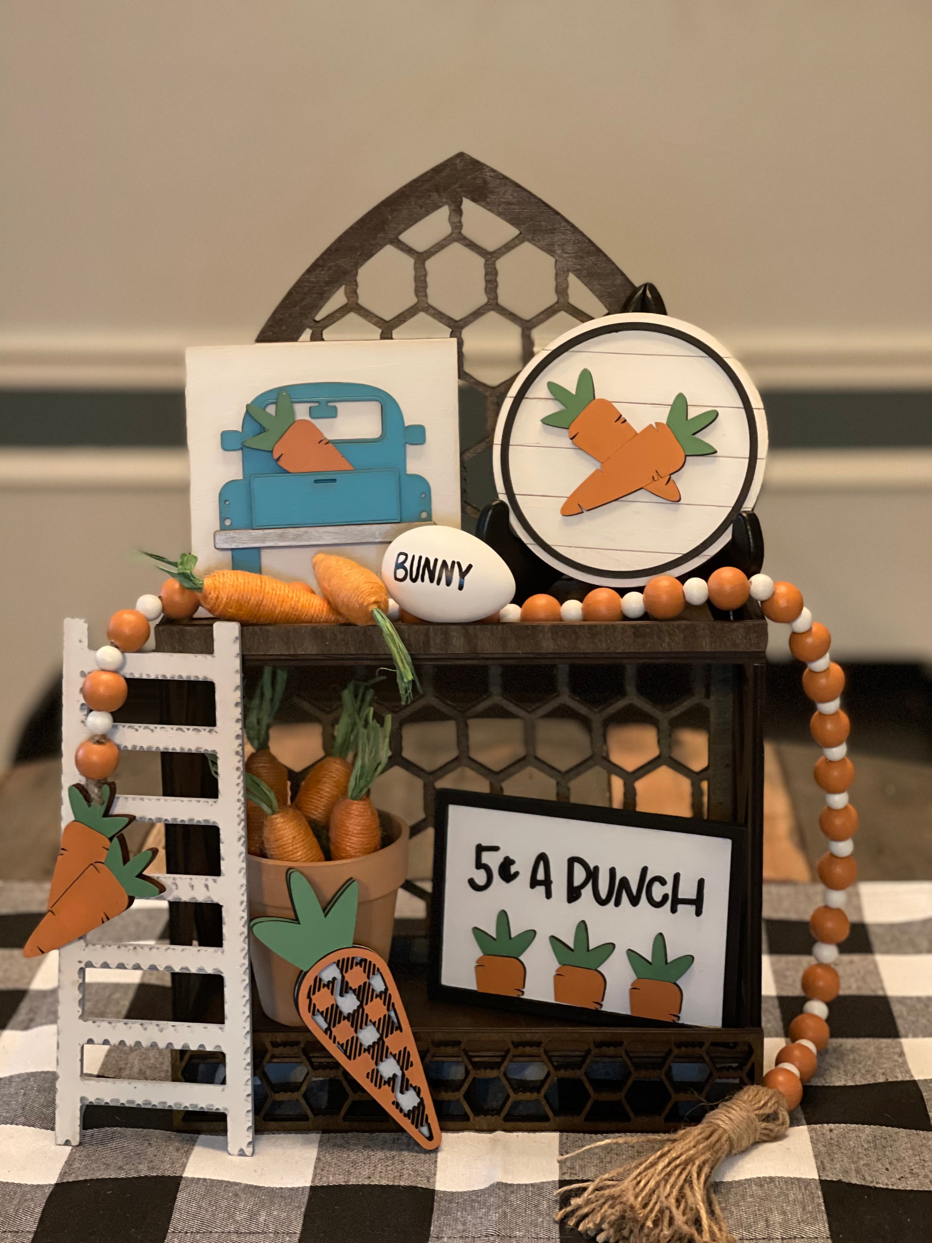This carrot patch 3D decor comes as a set. Cathedral tiered tray not included. Set comes with 1 5x5 blue vintage 3D truck, 1 5" round shiplap 3D carrot sign, 1 35" orange and white beaded garland with twine tassels, 1 5 cent a bunch (4x6") 3D frame sign, 1 3D buffalo plaid carrot ( 5.5x2") and a 9" wood ladder.