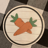 This 5x5" round shiplap sign shows 3D carrots attached with a black wood boarder.
