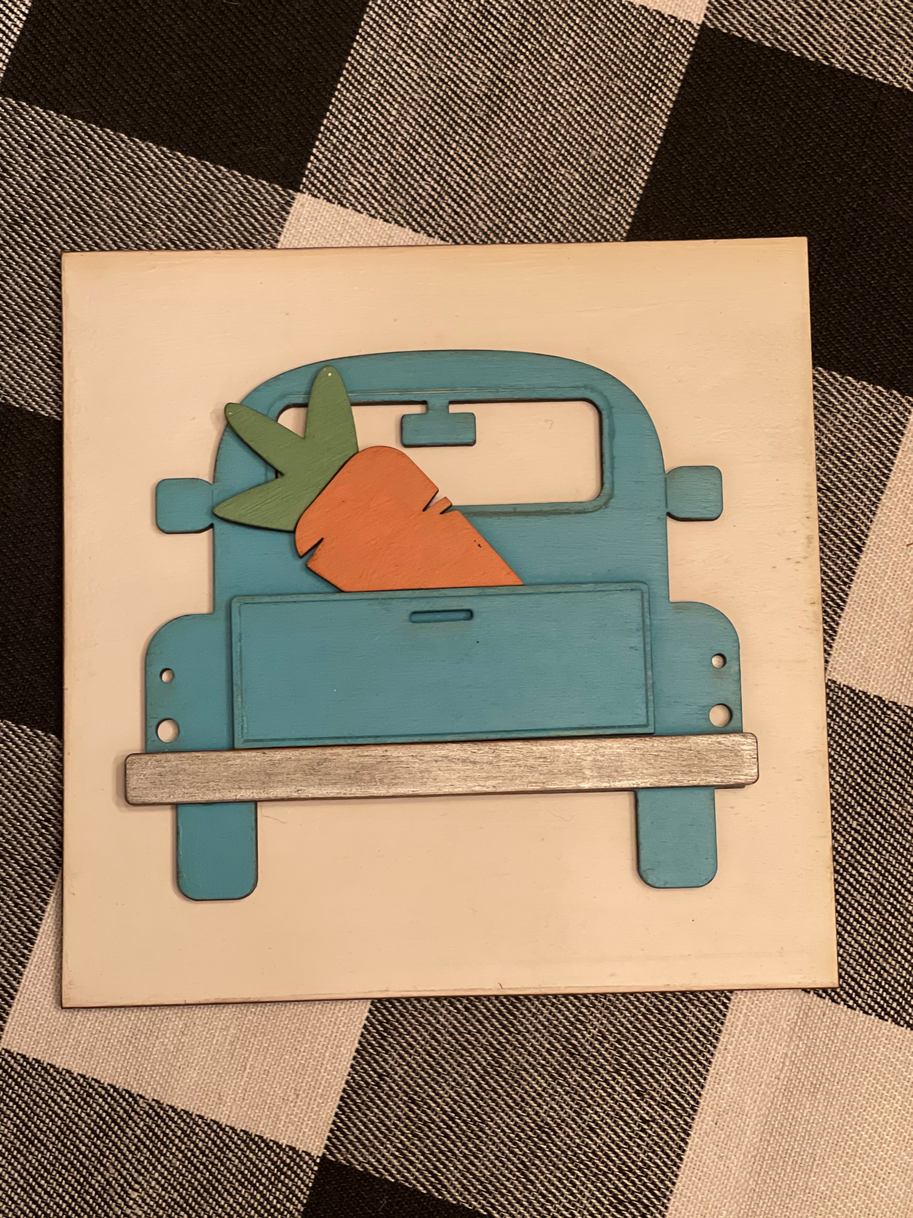 This is the 3D vintage blue truck with a carrot in the back of the bed.