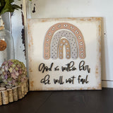 This image shows the canvas sign displayed on a bench next to decor pieces.