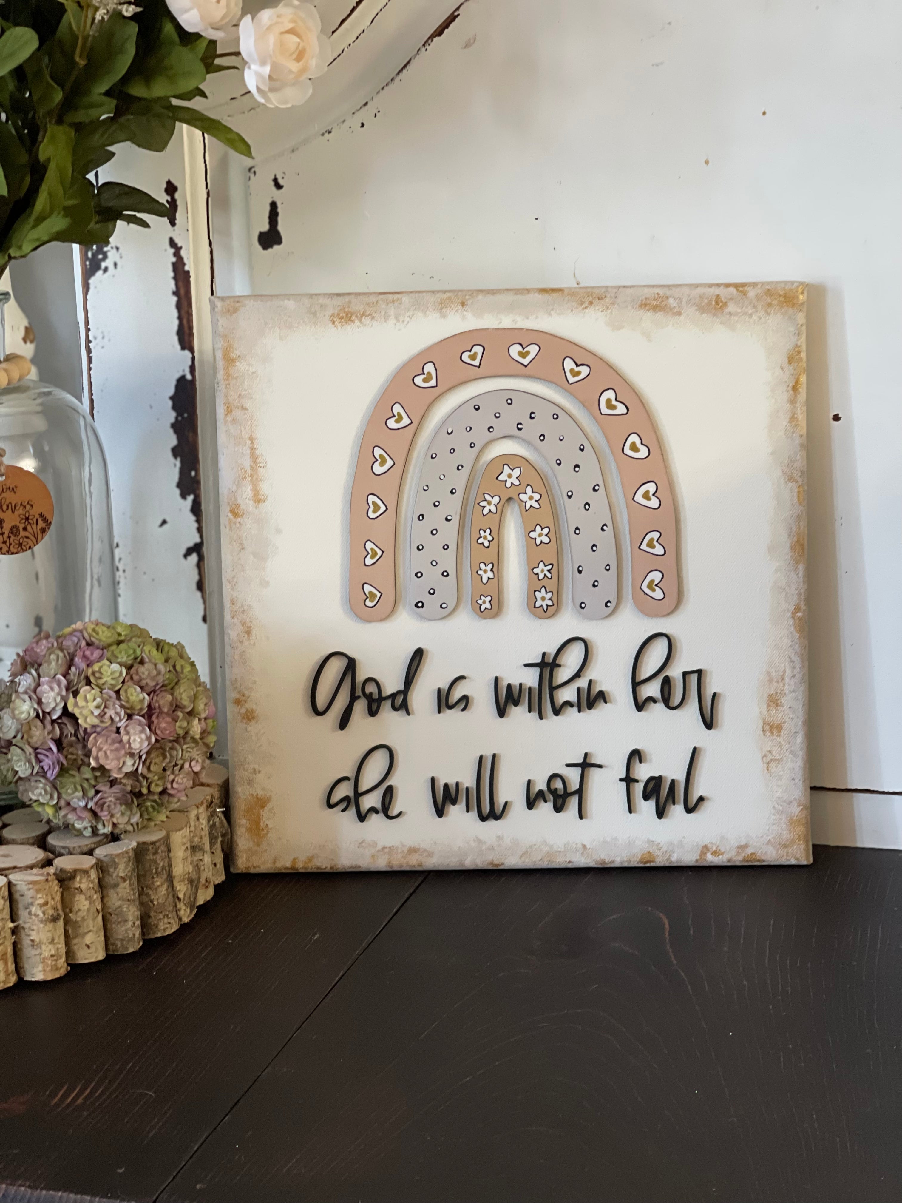 This image shows the canvas sign displayed on a bench next to decor pieces.