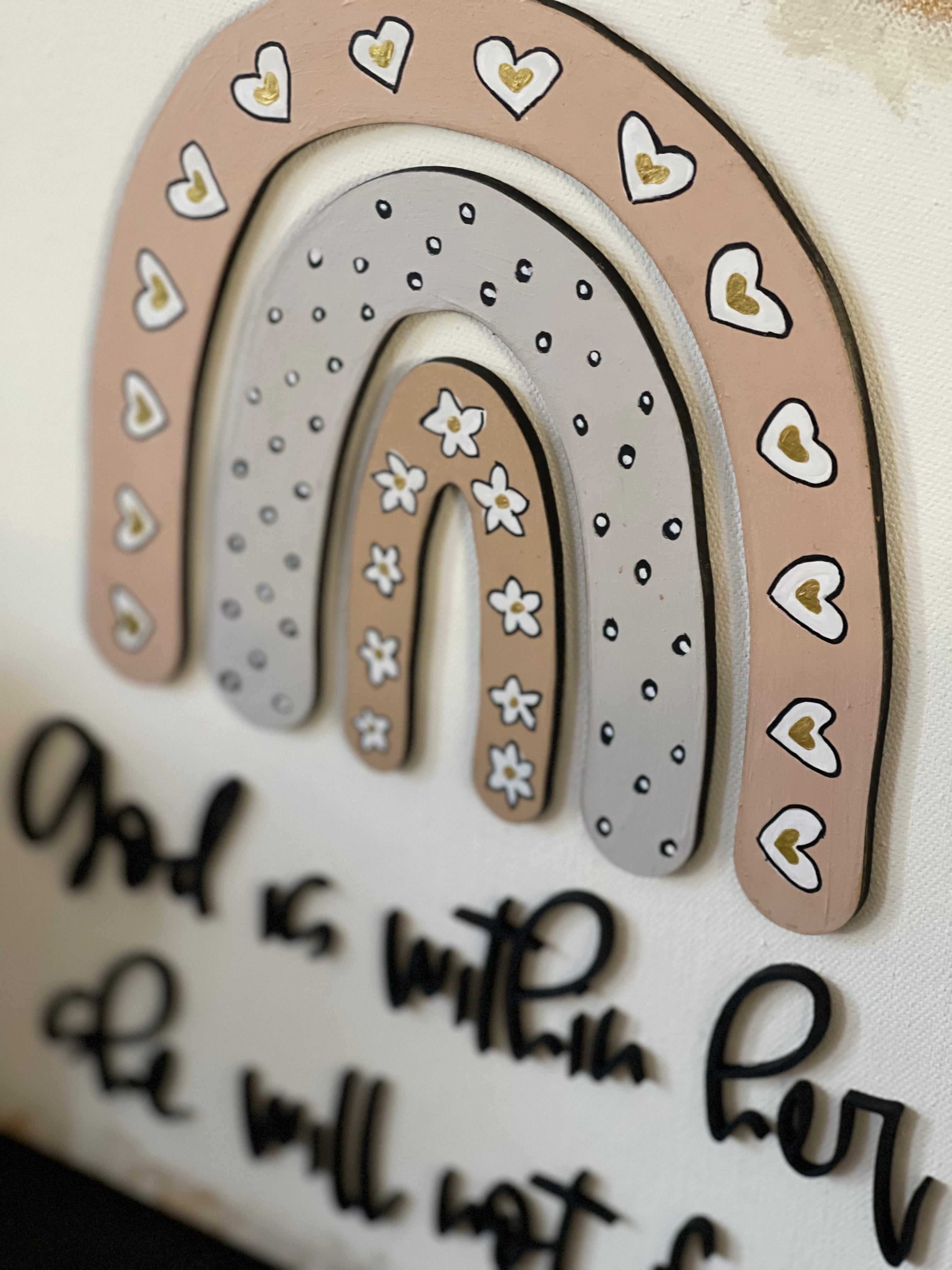 This image show the hand painted details on the rainbows. Hearts, dots and flowers.