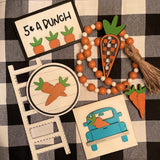 This is an alternate photo of all the tiered tray decor items laying on a table displayed together.