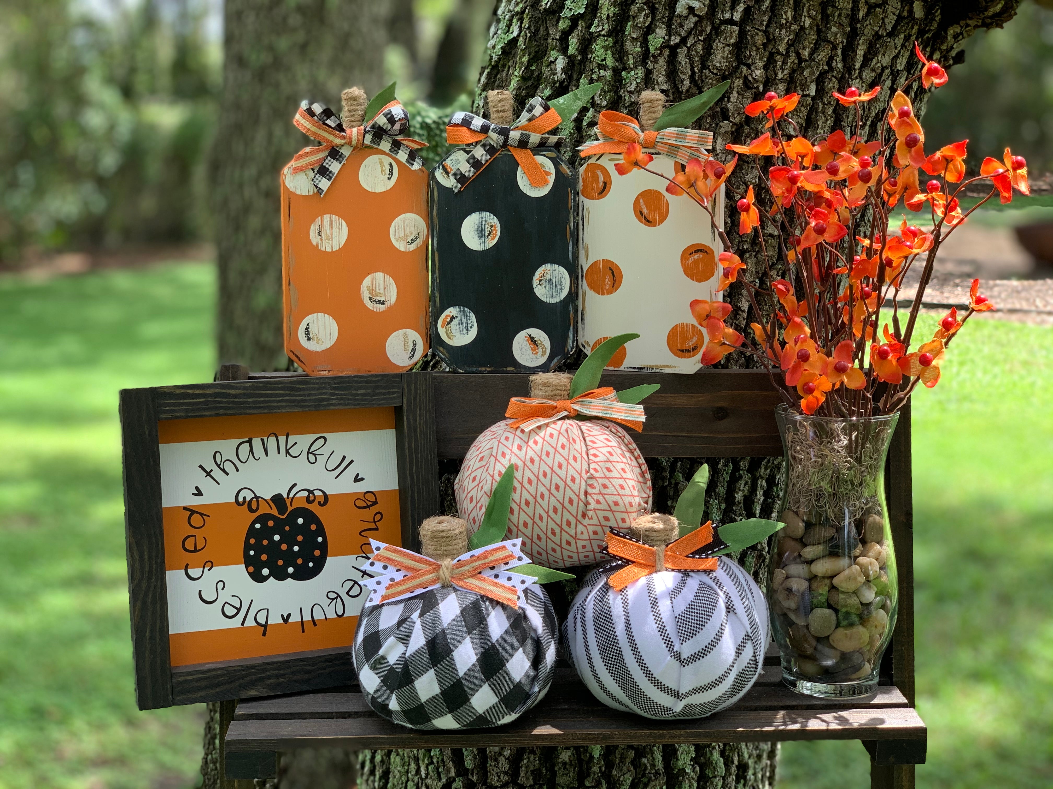 This image shows the artificial bittersweet floral glass vase with our wood pumpkins and cloth pumpkins and a small hand painted sign.  Each item sold separately.