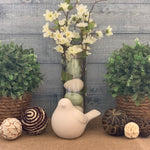 Topiary with Twine Rope shows an image of the topiary sitting on a table as an arrangement with a second topiary, a floral arrangement, a porcelain bird, and decorative balls.