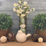 Topiary with Twine Rope shows an image of the topiary sitting on a table as an arrangement with a second topiary, a floral arrangement, a porcelain bird, and decorative balls.