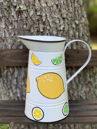 White Metal Lemon and Lime Pitcher shows an image of the pitcher sitting on a ladder outside.
