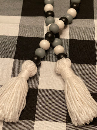 This is a close up image showing the white yarn tassels.