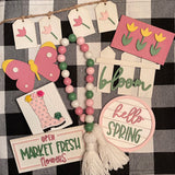 This set includes 1 tulip banner, 1 tulip mini 3D sign, 1 3D mini butterfly, 1 3D fence cutout that says bloom, 1 mini round shiplap sign that says hello Spring, 1 mini market fresh flower sign, 1 mini 3D rain boot sign with flowers, and 1 25" wood bead garland.