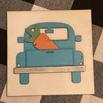 This is the 3D vintage blue truck with a carrot in the back of the bed.