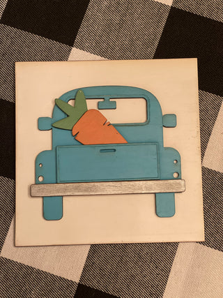 This is the 3D vintage blue truck with a carrot in the back of the bed.