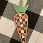 This 3D buffalo plaid carrot is shown displayed on a table.