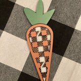 This 3D buffalo plaid carrot is shown displayed on a table.