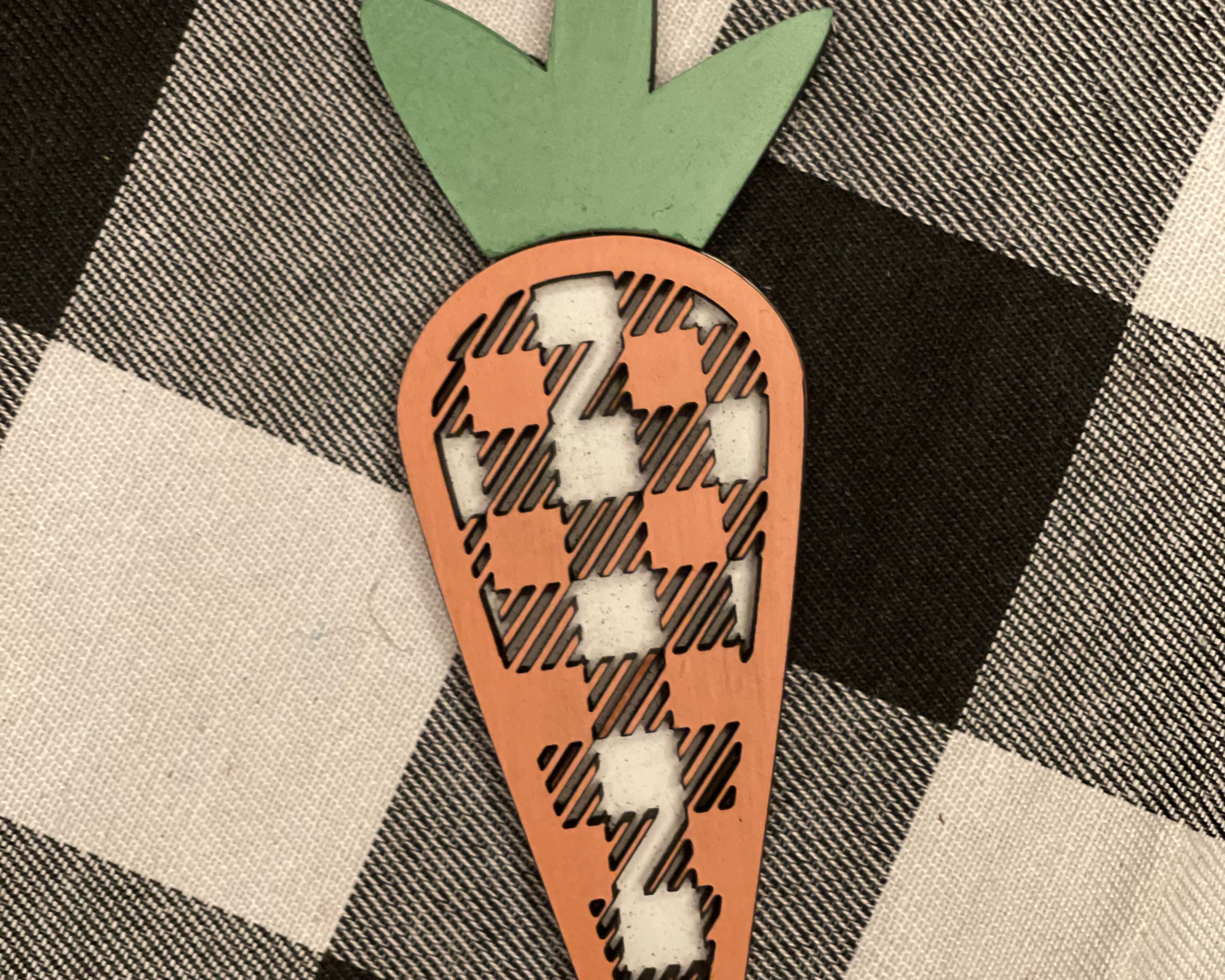 This 3D buffalo plaid carrot is shown displayed on a table.