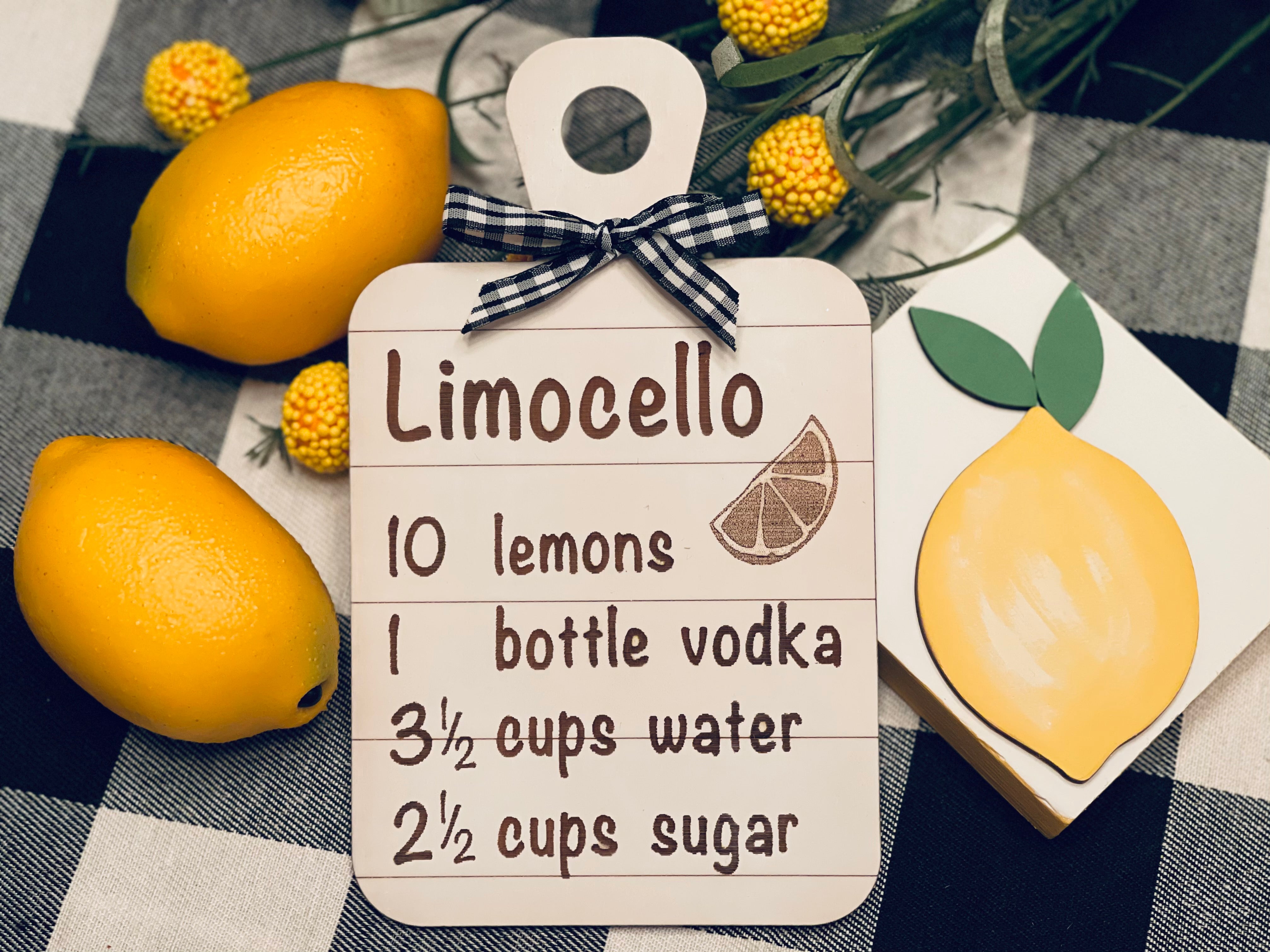 This mini shiplap cutting board sign has an engraved Limocello recipe with a buffalo check ribbon attached.  For decorative use only. Item not sold with other products shown in picture.