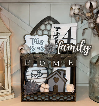 This home tiered tray set in shown in our new Cathedral two tiered tray.  This five piece set comes with This is us mini sign, a 5x5 square party of 4 mini sign, a family script sign, a 3D mini cutout house, and the mini home banner.  The five piece set can be purchased together or individually.  