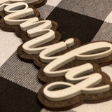 This is an alternate image of the family script sign showing the wood cutout.