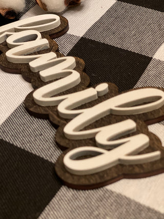 This is an alternate image of the family script sign showing the wood cutout.