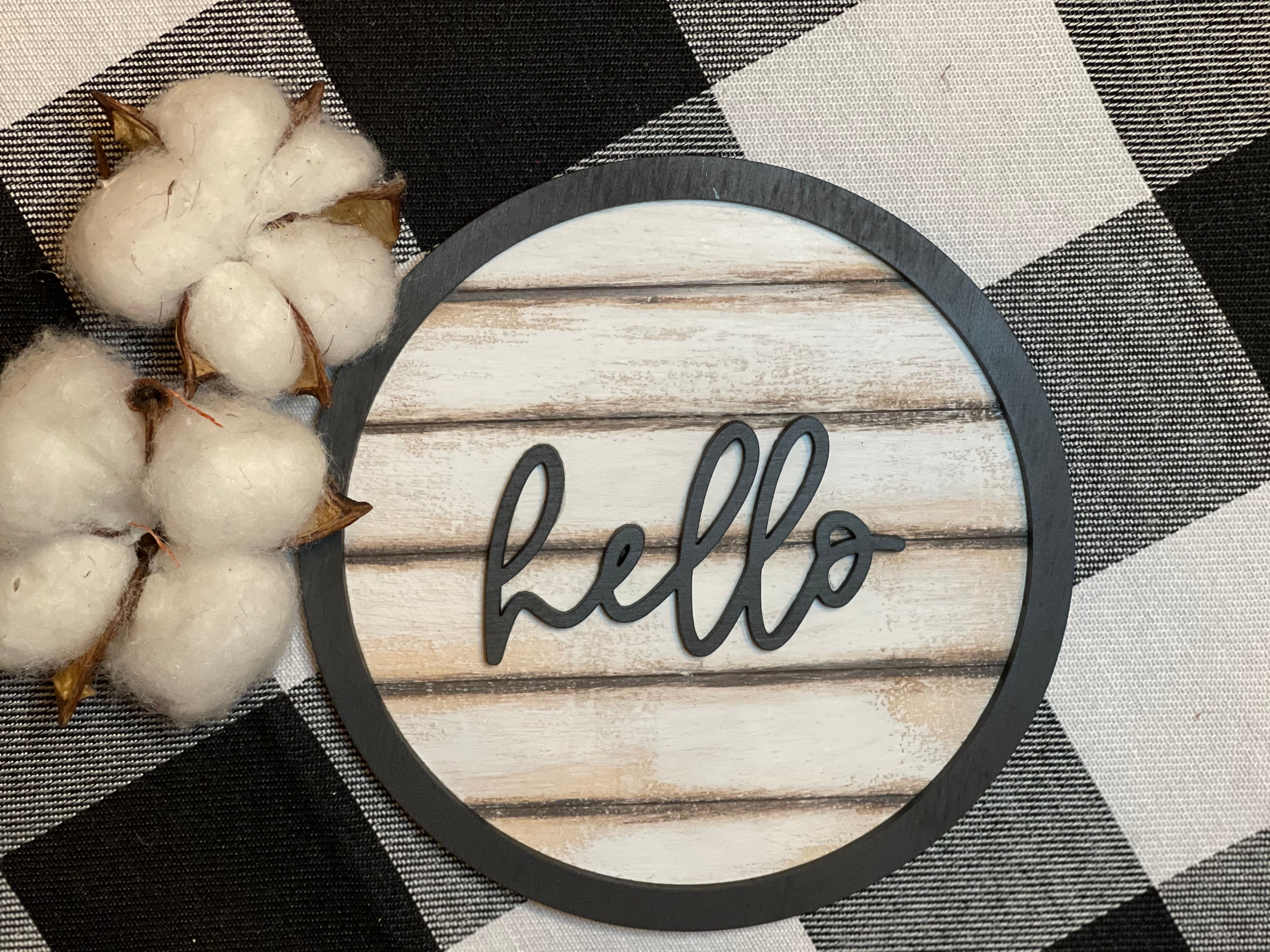 Our 3D hello 5" round shiplap sign has a script hello wood cutout attached to the mini shiplap wood sign.  With a black cutout round wood boarder, this sign screams cuteness!  Add to any tiered tray, vignette, or shelf.  Works best with a mini easel, which is sold separately.