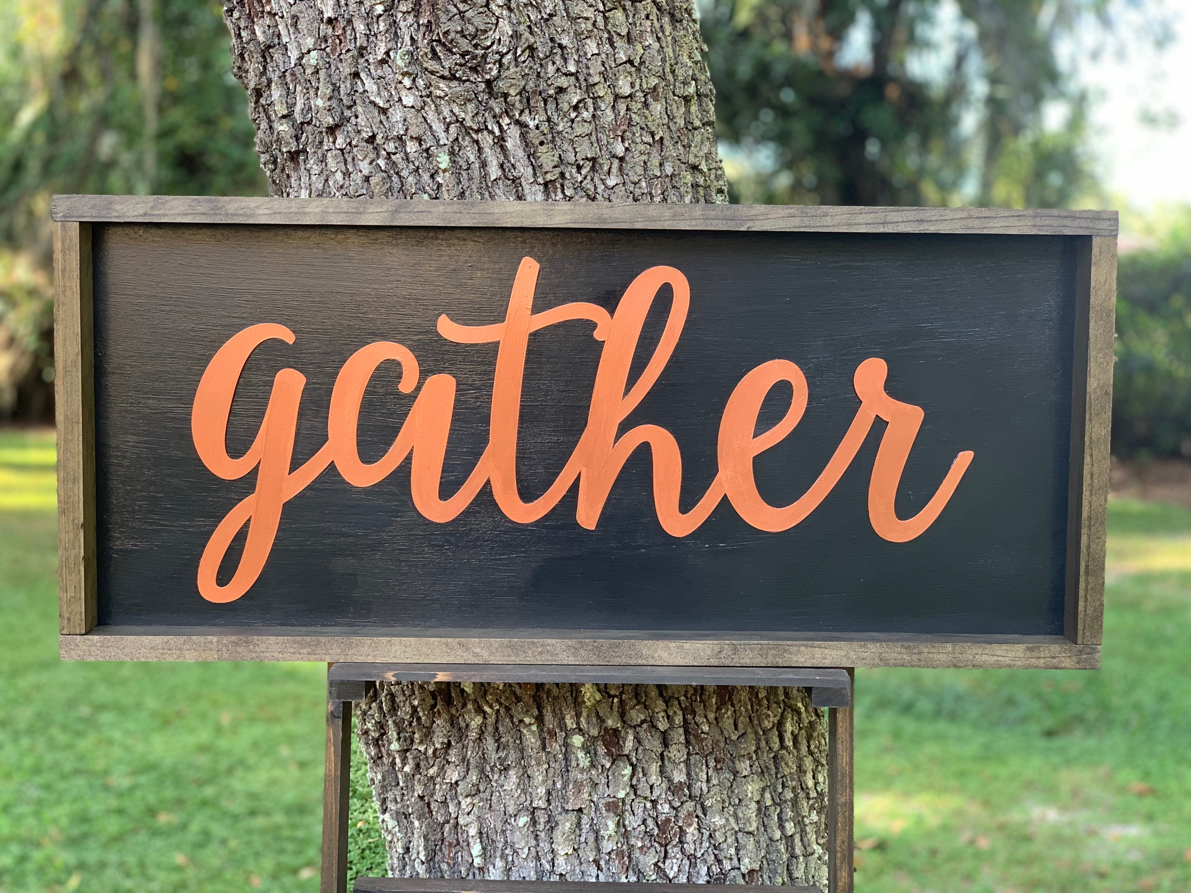 Metallic Gather Sign shows an image of the sign sitting outside on a ladder.