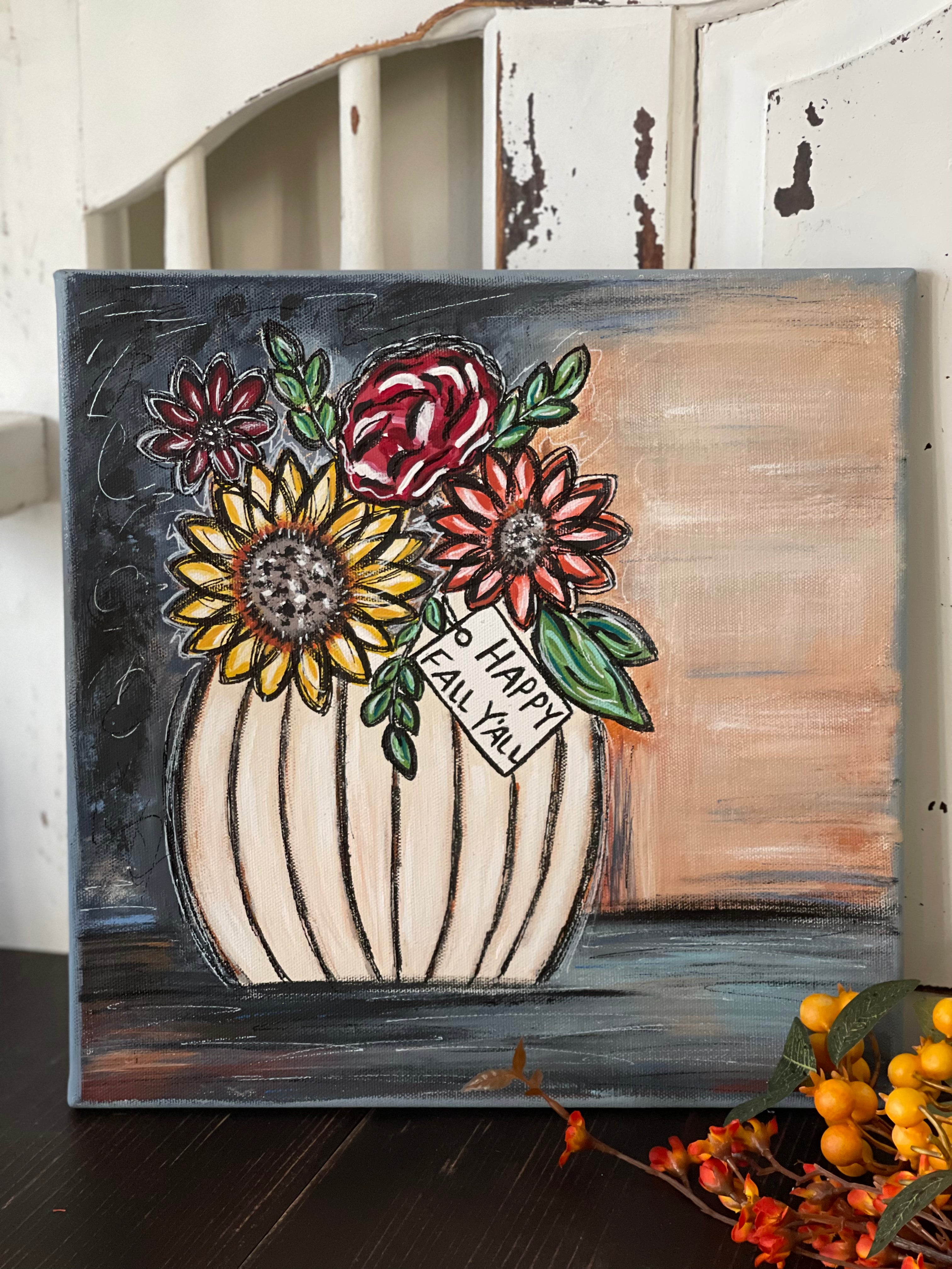 This image shows the hand painted sign displayed on a bench with fall floral flowers.