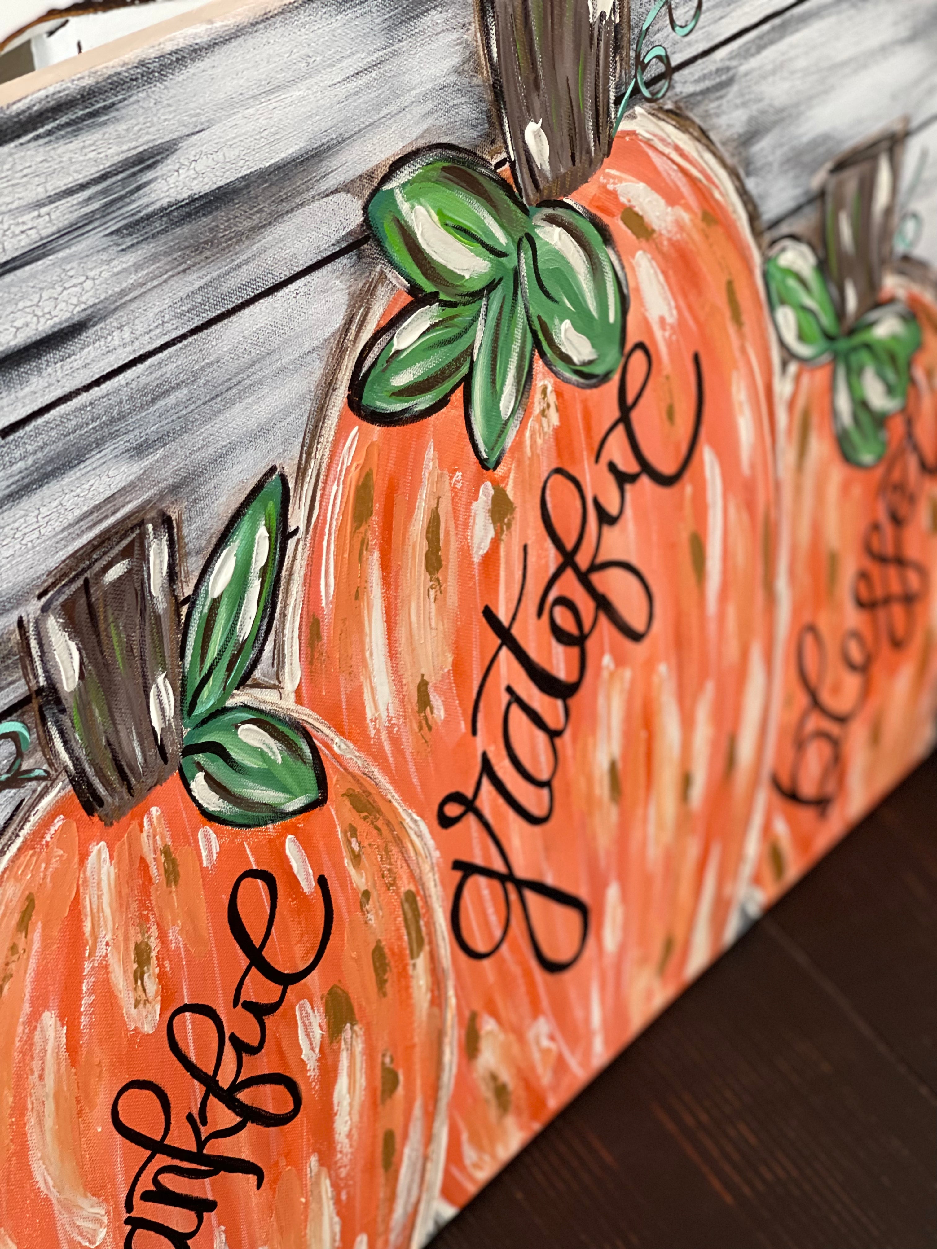 This image shows an alternative angle of the canvas with the hand painted pumpkins.