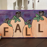 This image shows the fall 3D textured pumpkins displayed on a bench. 