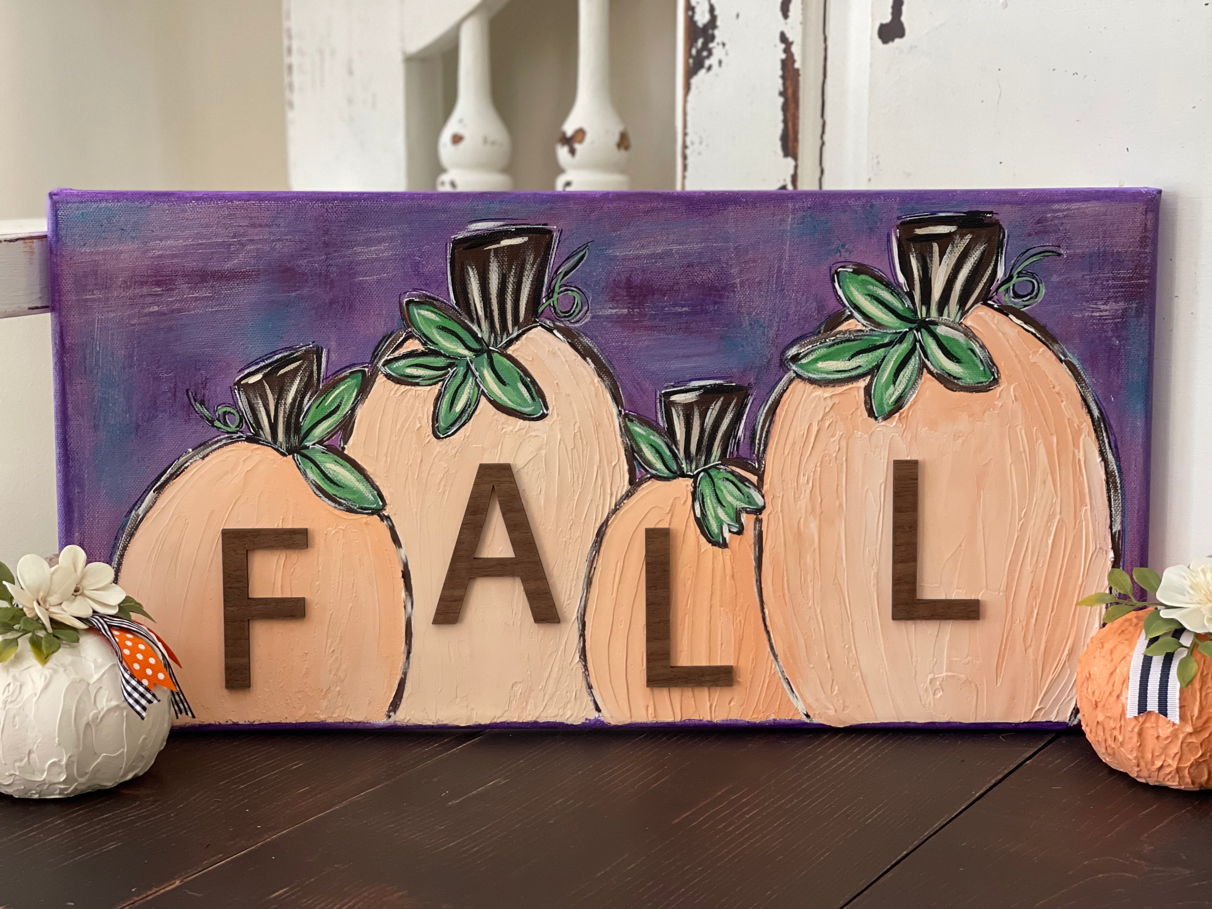 This image shows the fall 3D textured pumpkins displayed on a bench. 