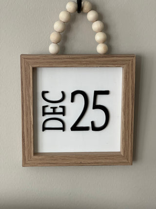 This image shows the DEC 25 hanging on a hook.