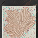 This image shows the warm beige leaf with small polka dots.  It has a textured pattern.