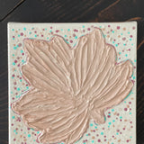This image shows the warm beige leaf with small polka dots.  It has a textured pattern.