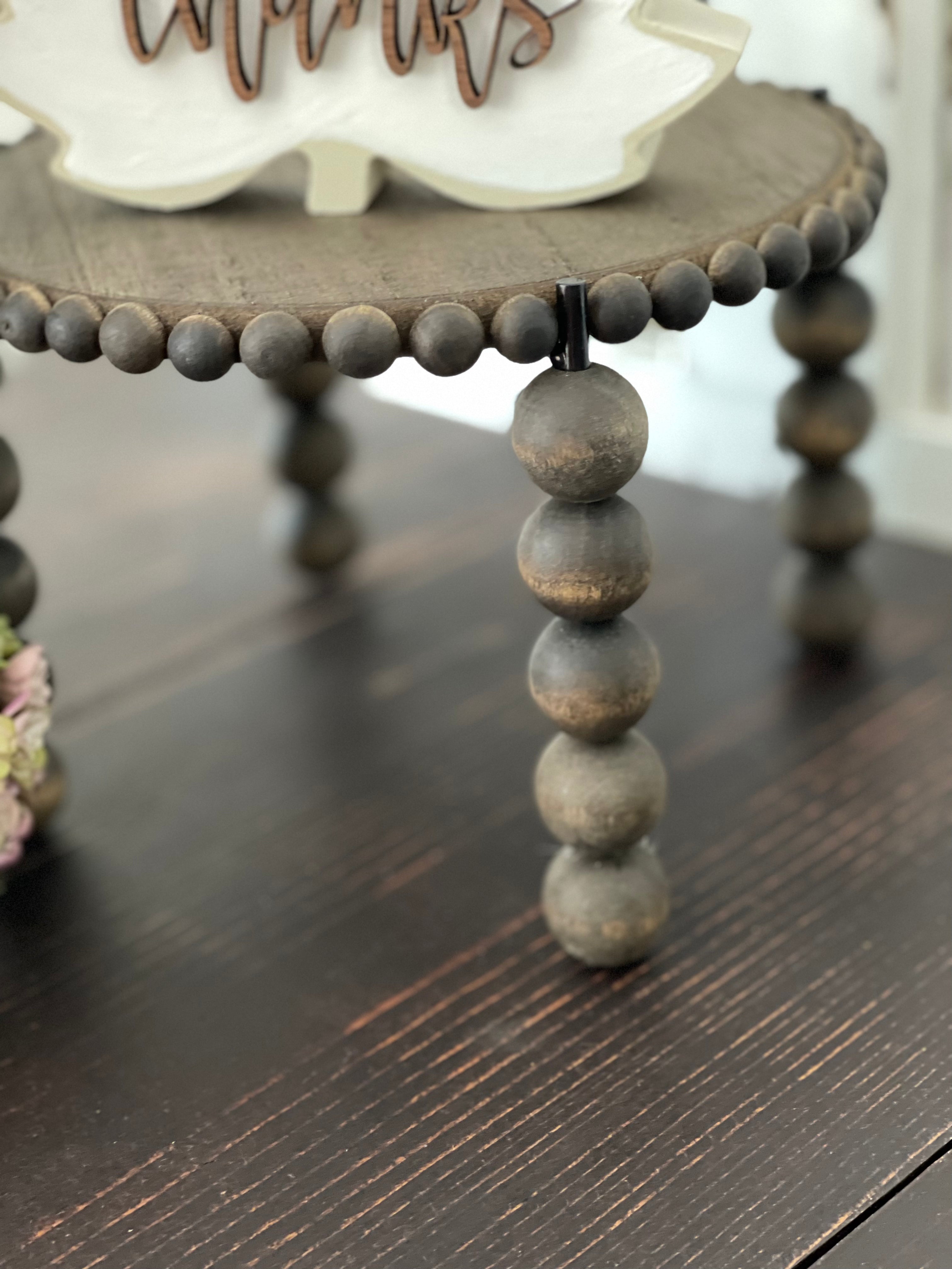 This image shows the close up beads on the legs of the stand and the top.