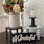 This image shows the paired Jacobean and distressed white risers on a bench with a floral arrangement, candle and a grateful sign. Each item sold separately.