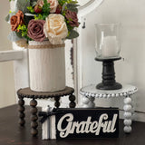 This image shows the paired Jacobean and distressed white risers on a bench with a floral arrangement, candle and a grateful sign. Each item sold separately.