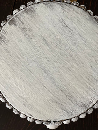 This image shows the top of the white distressed stand.