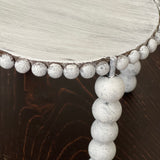 This image shows the white distressed beads.