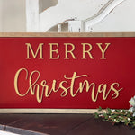 This is the red and tan Merry Christmas sign, displayed on a bench.