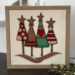 This image shows the Christmas tree sign displayed on a bench.