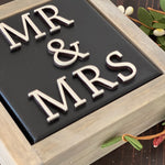 This image is a close up of the 3D lettering.This sign is black with white lettering.