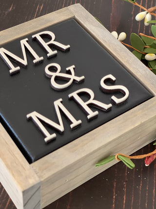 This image is a close up of the 3D lettering.This sign is black with white lettering.