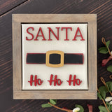 This image shows the santa sign with wood cutouts and a wood stained frame.