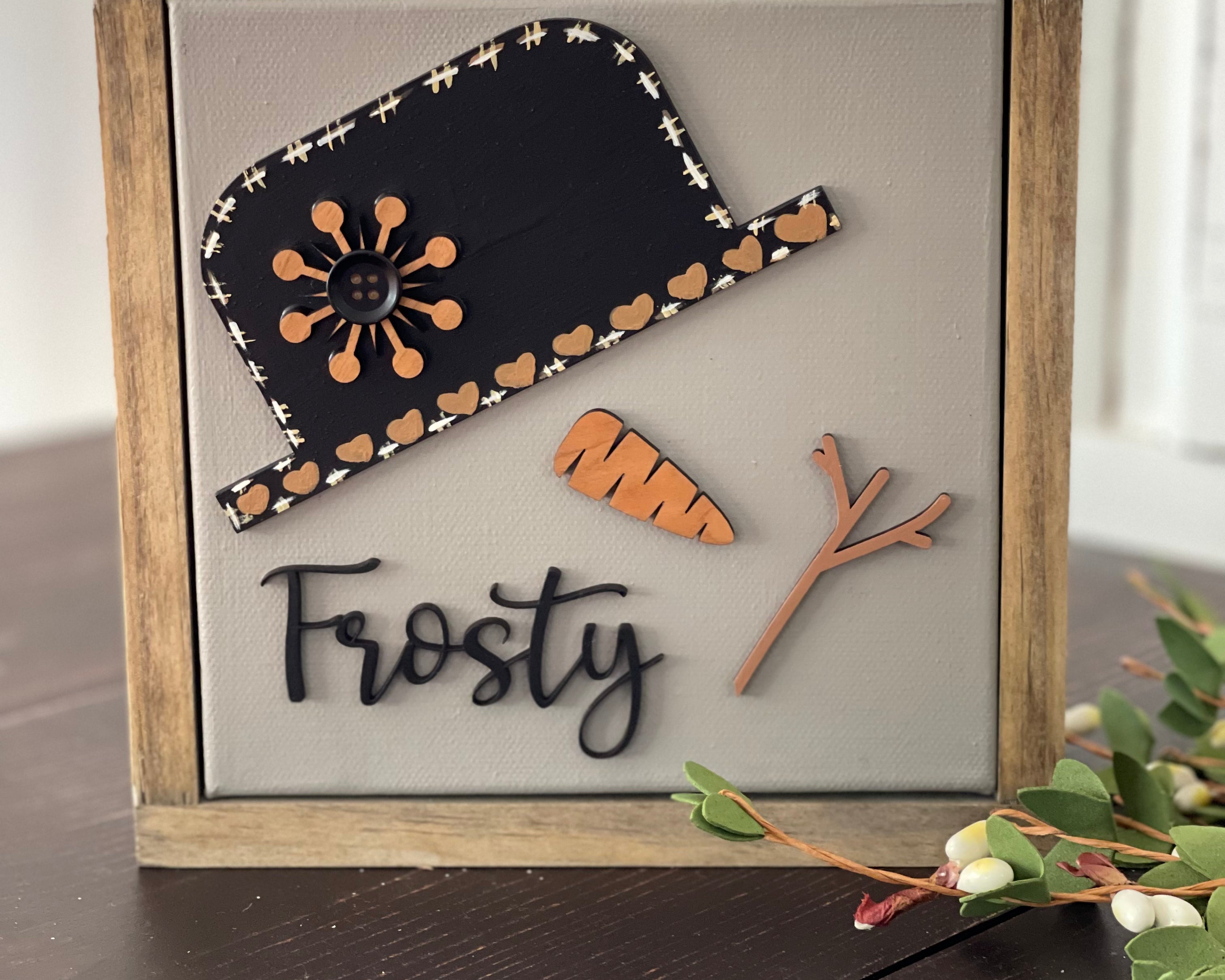 This image shows the Frosty sign standing up on a bench.