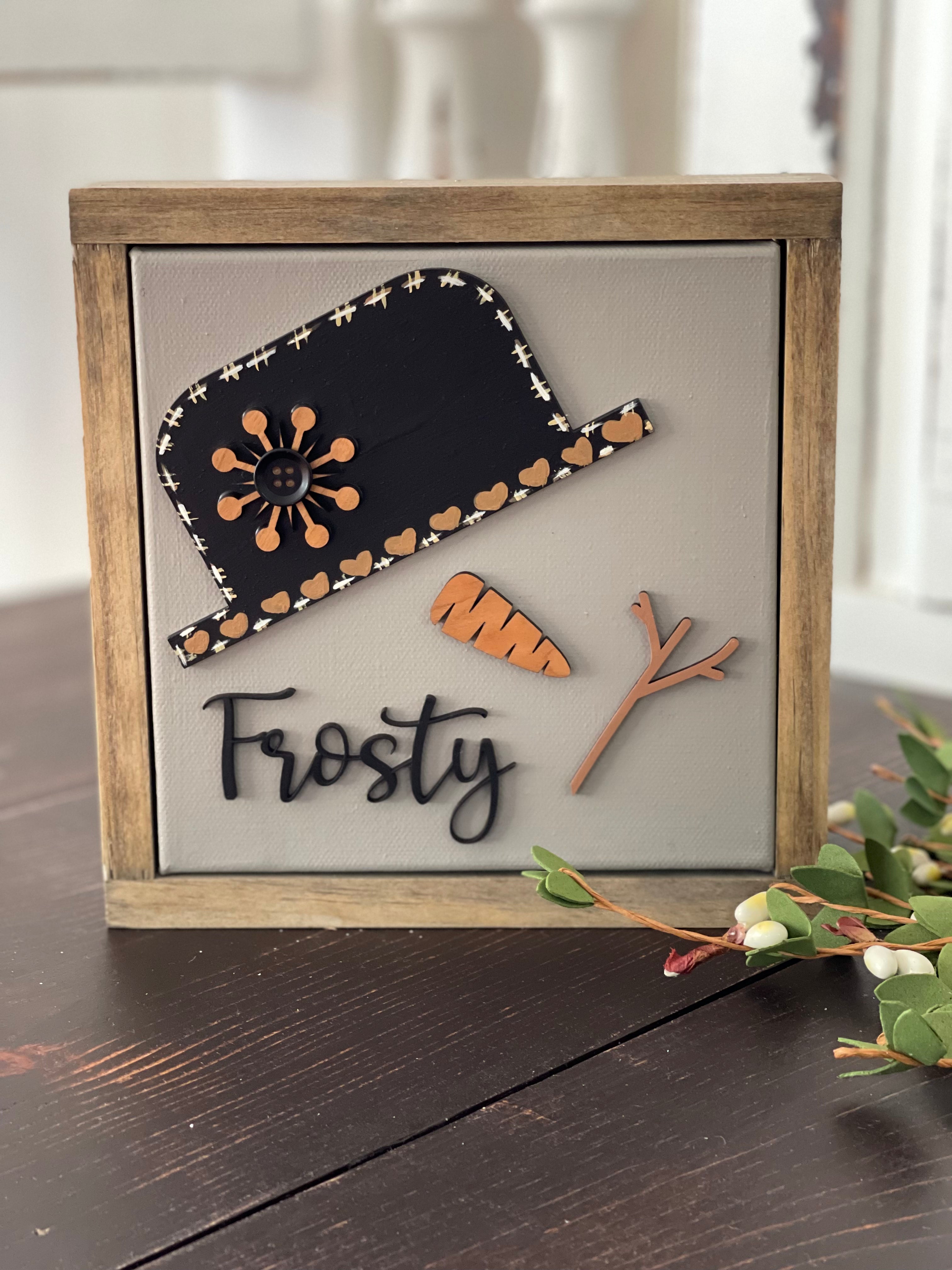 This image shows the Frosty sign standing up on a bench.