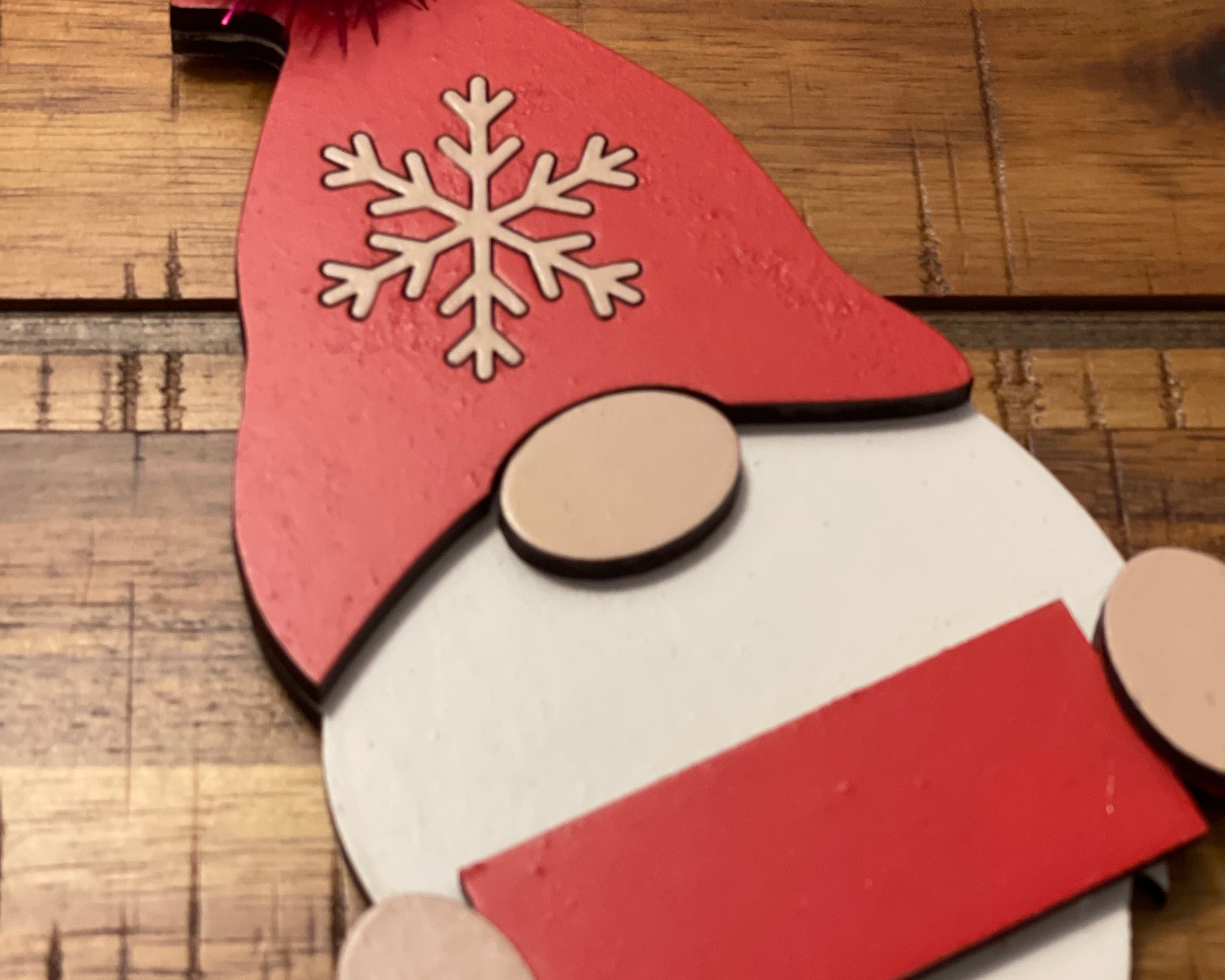 This is the red gnome displayed on a wood table.