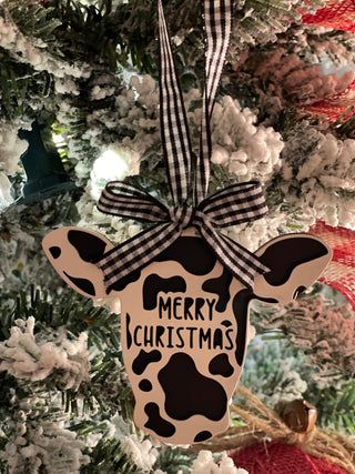 This is the black and white cow hanging on a tree.