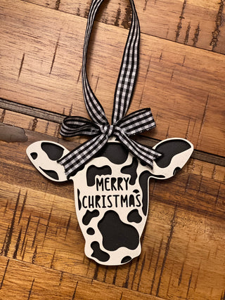 This is the black and white cow displayed on a wood table.