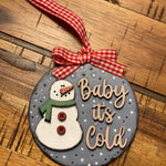This ornament is shown laying on a wood table.