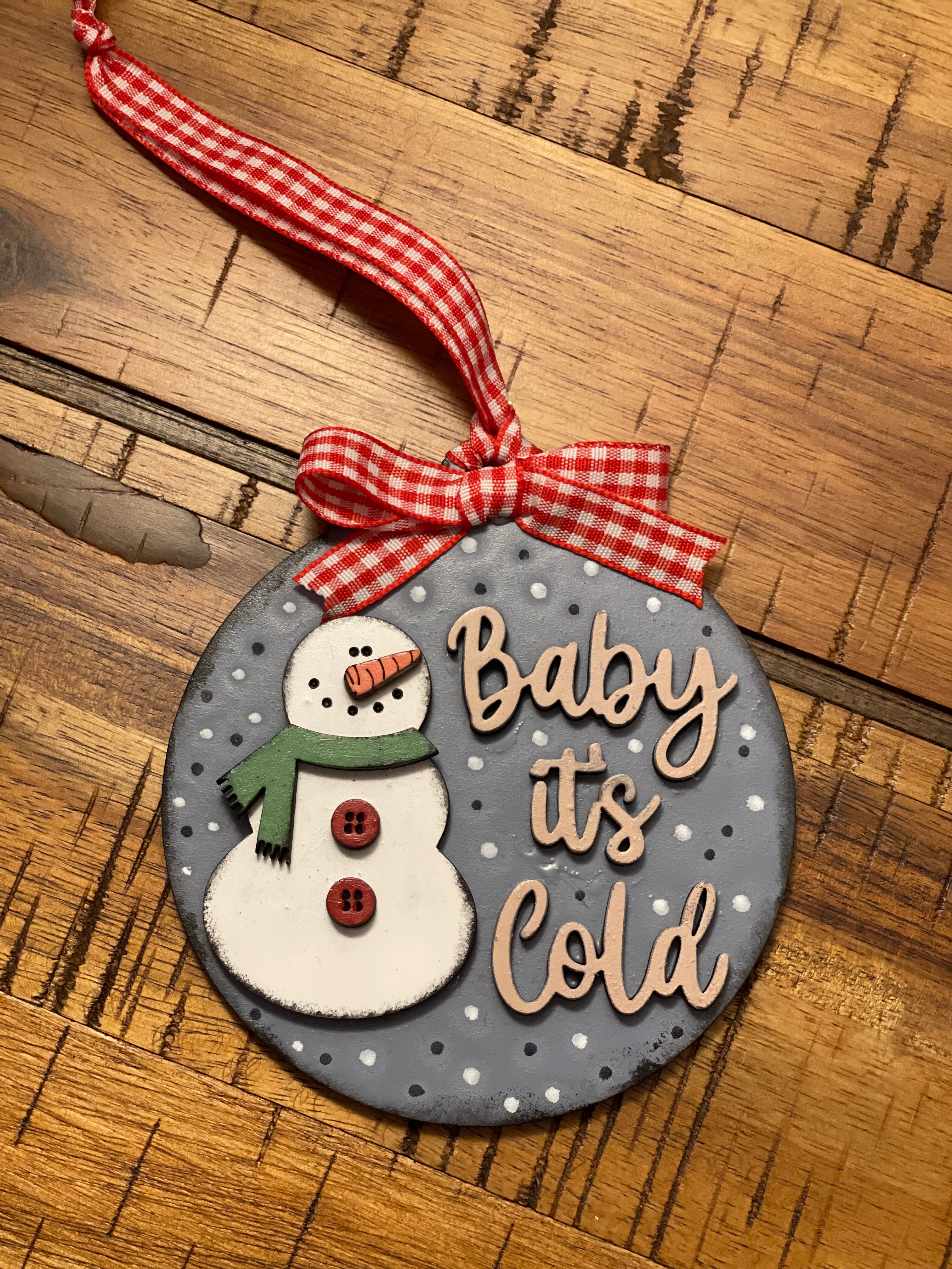 This ornament is shown laying on a wood table.