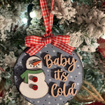 This ornament is displayed hanging on a tree.